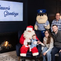 Baby boy on Santa's lap with parents and grandparents